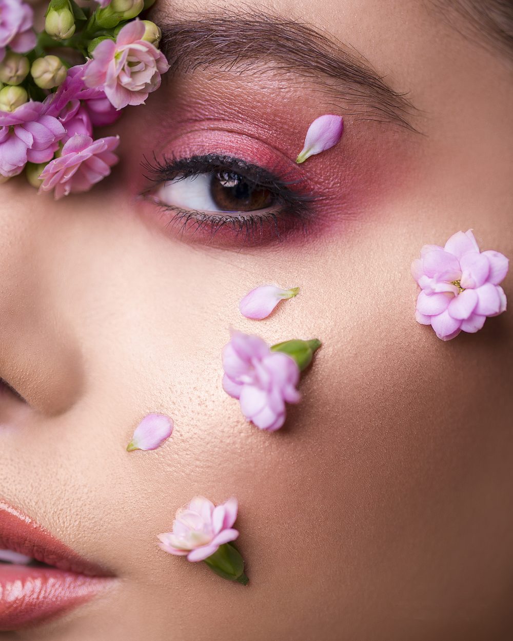 Model mit Blüten im Gesicht – natürliche Hautpflege bei HautDLuxe